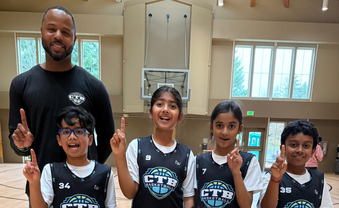 Coach with young kids in basketball jersey
