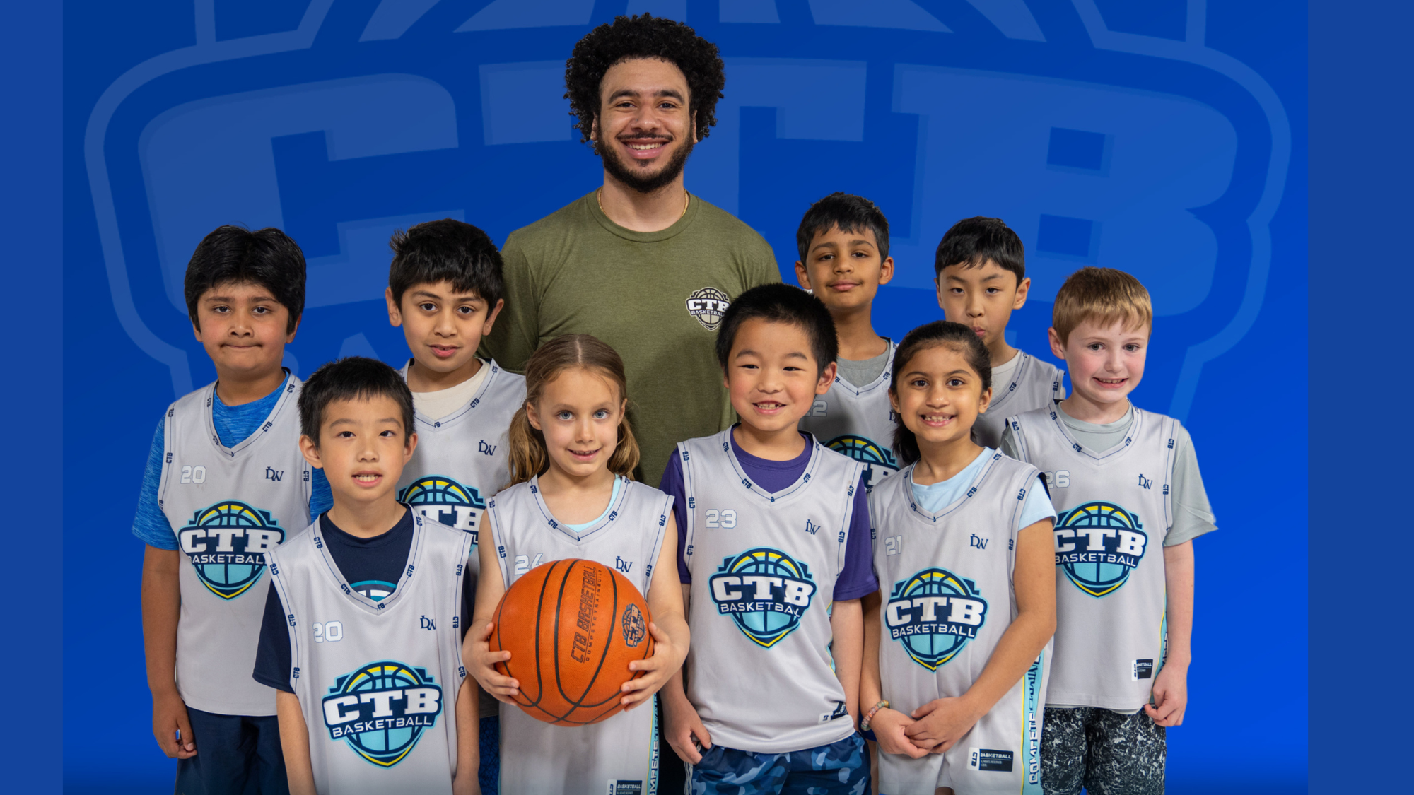 Coach with young kids in basketball jersey